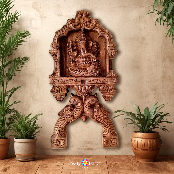 Woodcarved Ganesha & Laxmi kavadi style wall mounts with parrot carvings .