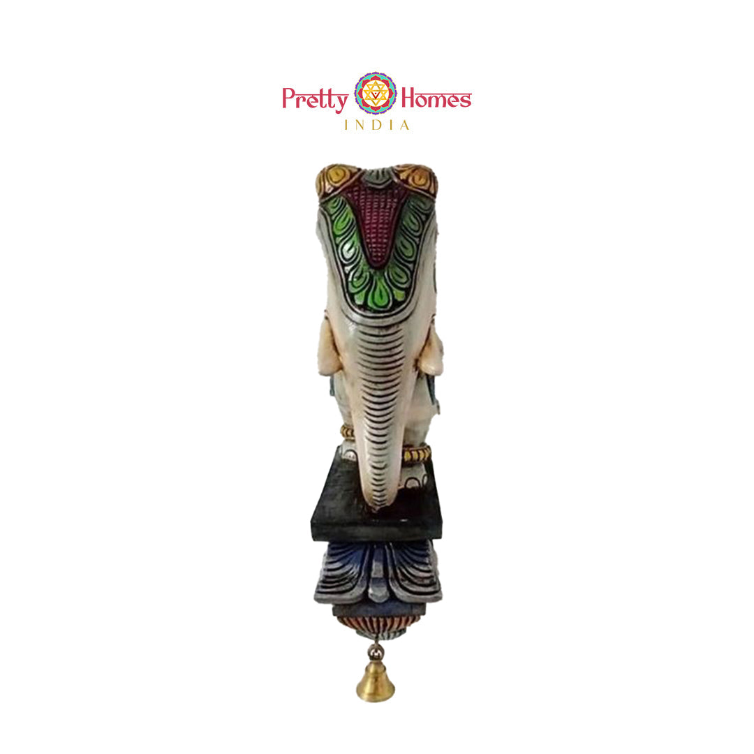 Wooden wall bracket featuring elephant carving and traditional temple art