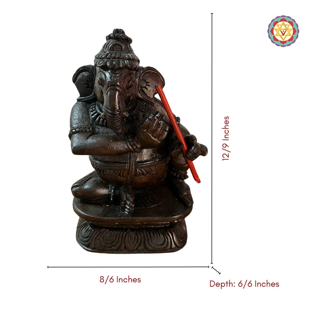 Close-up of colourful Ganesh statue playing violin carved from wood