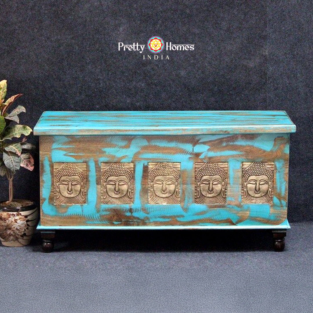 wooden storage trunk with brass buddha fittings used as a coffee table