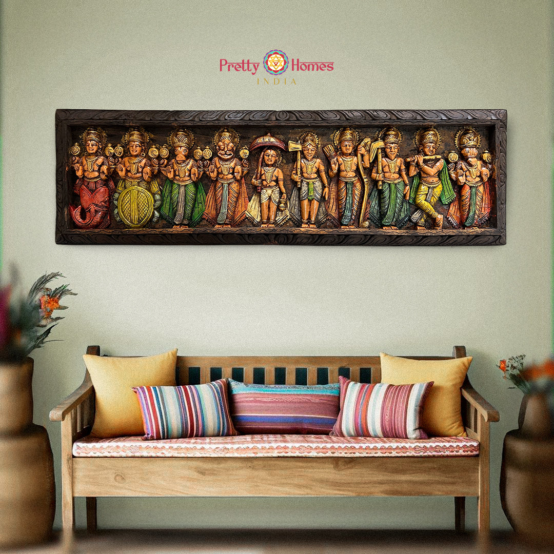 A large wall-mounted woodcarved panel depicting the ten primary incarnations or Avatars of Vishnu, with colorful figures displayed on a wooden frame, placed above a bench with cushions in a home setting.