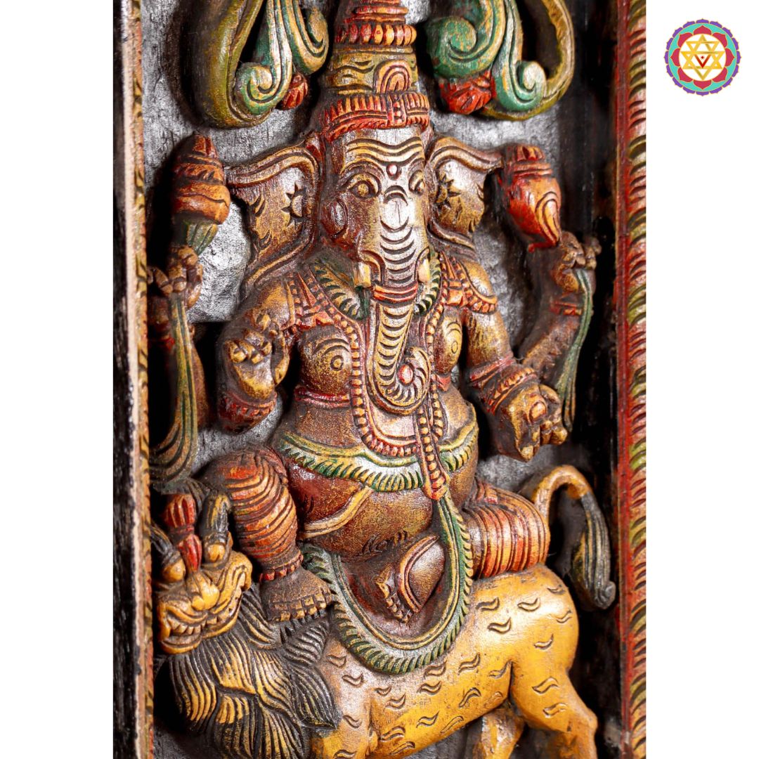 Side angle of vertical wooden Ganesha panel showing intricate carving