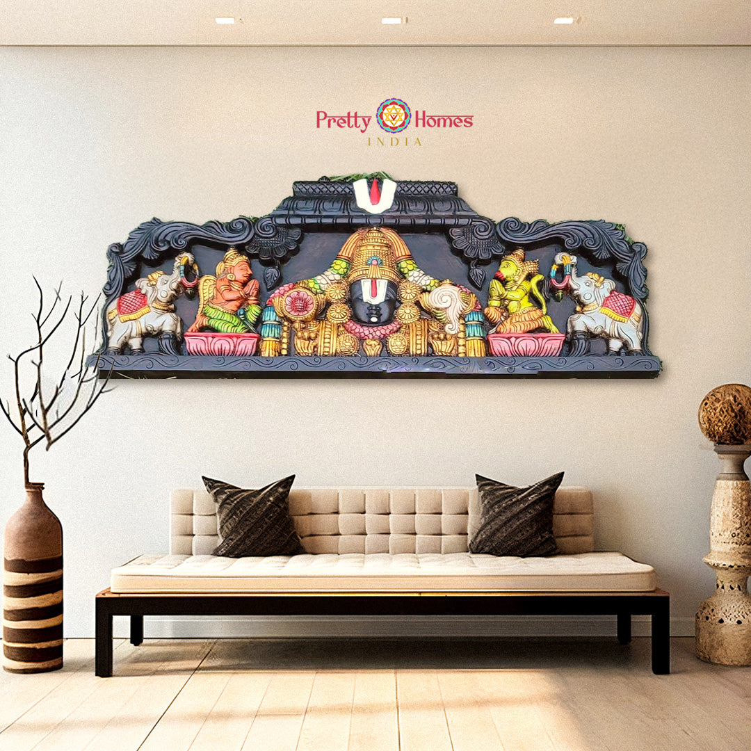 Decorative wall art with colorful figures above a sofa in a living room setting - Shankh Chakra Namam wooden panel with Hanuman and Garuda