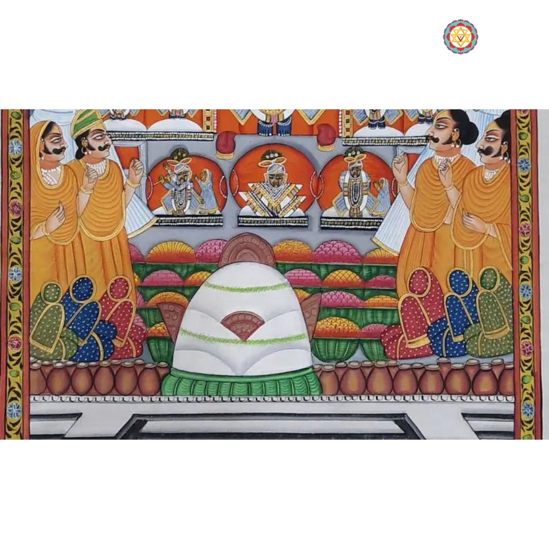 Pichwai altar scene with white shila, stacked offerings, and seated devotees in traditional dress