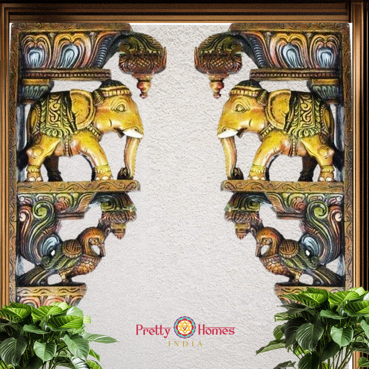 Golden-toned carved wooden elephant corbel pair with ornamental detailing and hanging hooks.