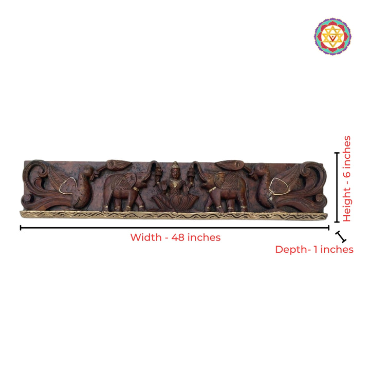 Intricate wood carving of Goddess Gajalaxmi with peacocks
