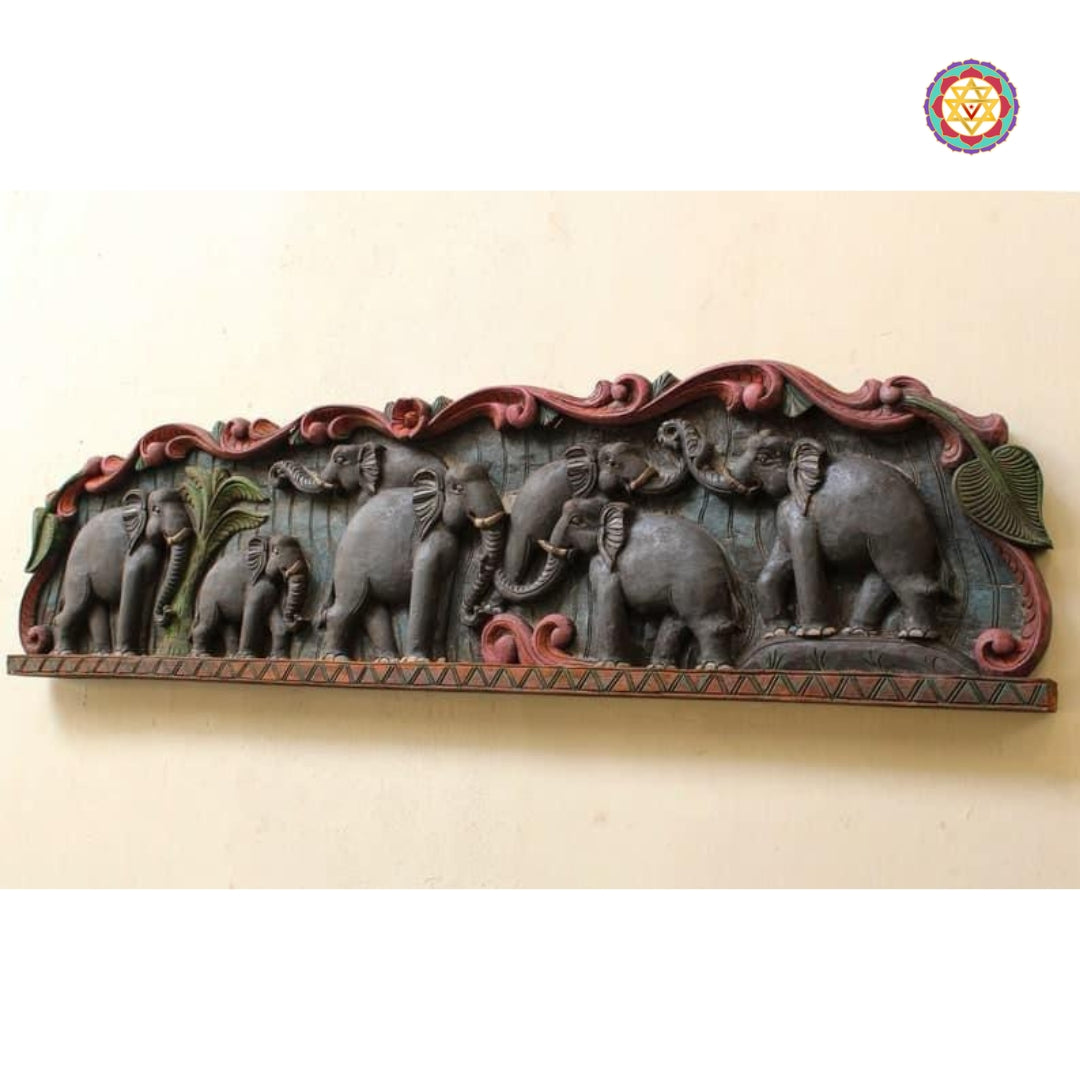Side view of carved elephant parade in panel