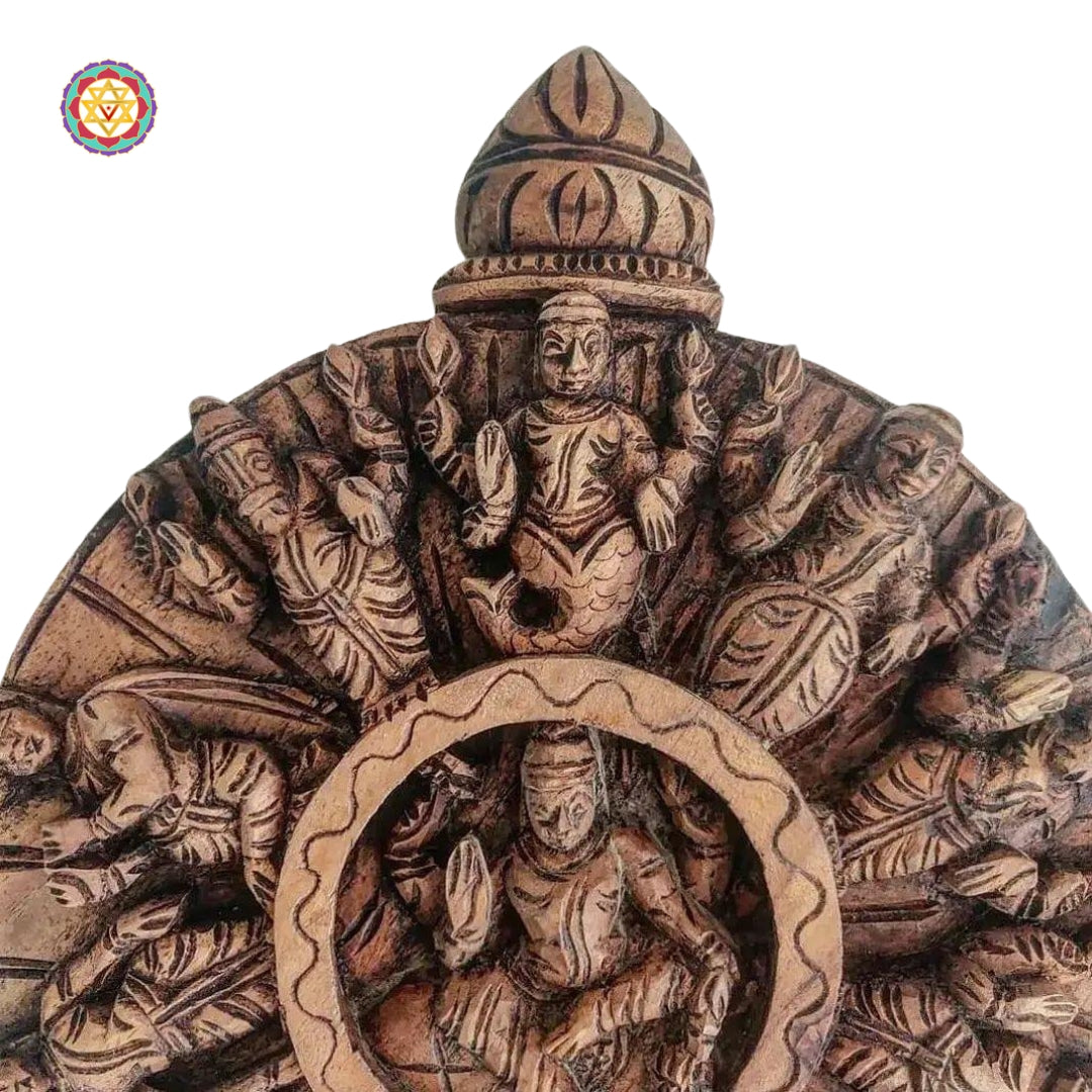 Traditional round wood carving representing Vishnu’s incarnations