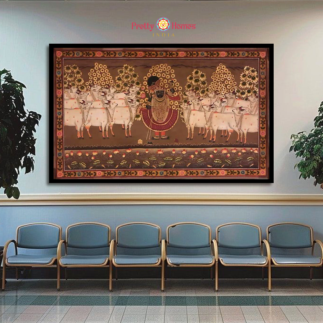 Hand-painted vintage style pichwai of Shrinathji with cows and floral trees, displayed in a modern seating area.