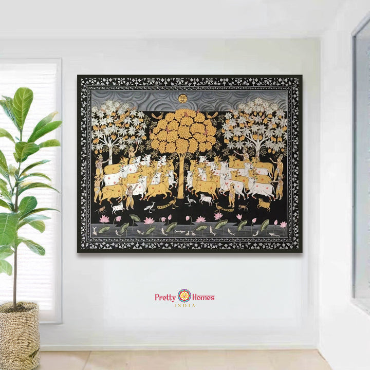 handpainted pichwai cows under trees with intricate floral border close-up highlighting tree foliage and delicate floral borderwork