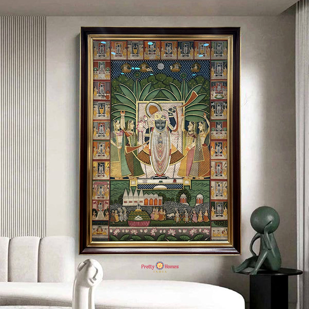Framed traditional painting of deity with gopis and ornate border panels staged in modern interior