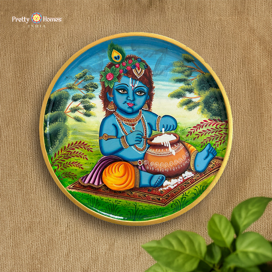 close up butter krishna plate showing gold accents and brush detailing