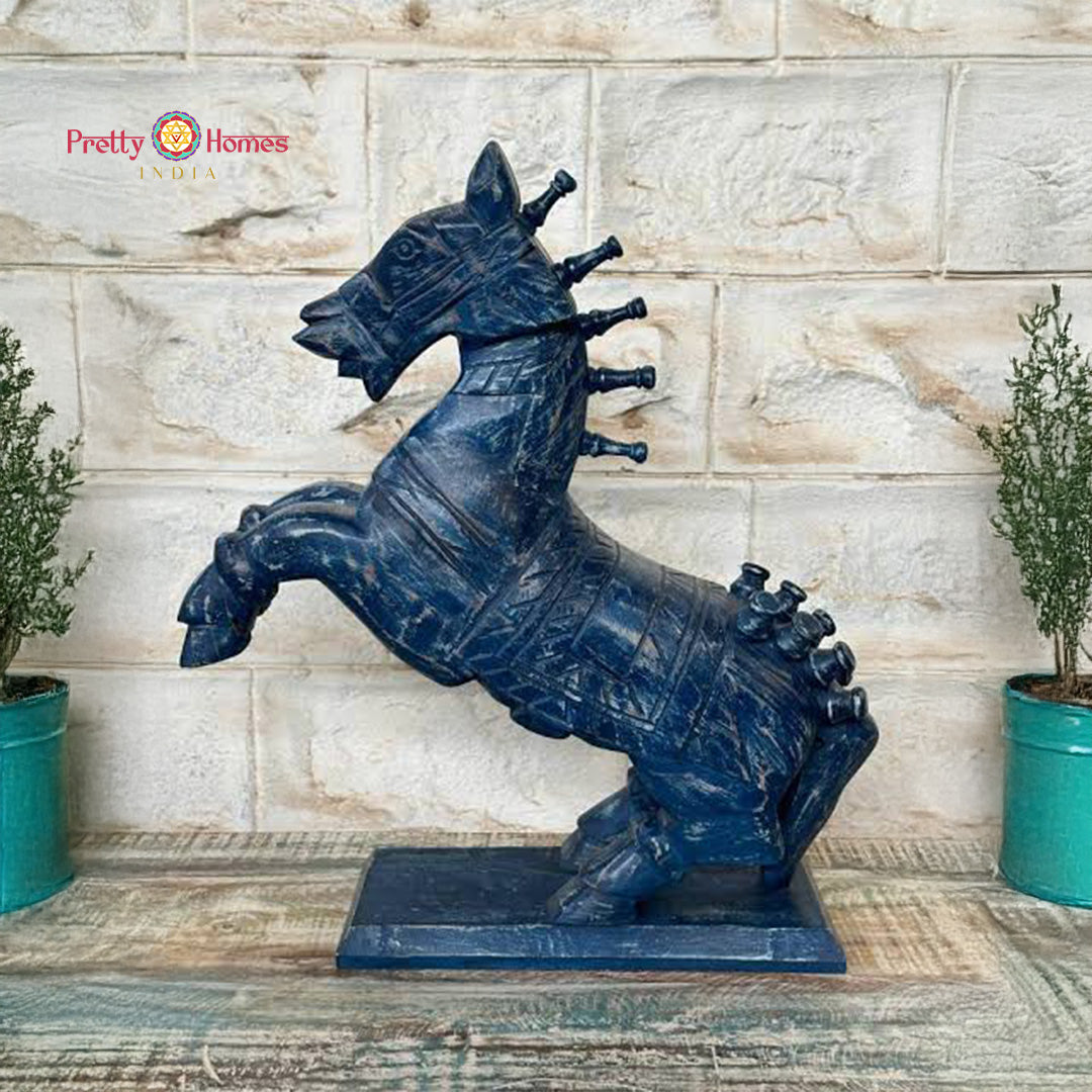 Lifestyle angled shot of handcrafted wooden horse in room styling