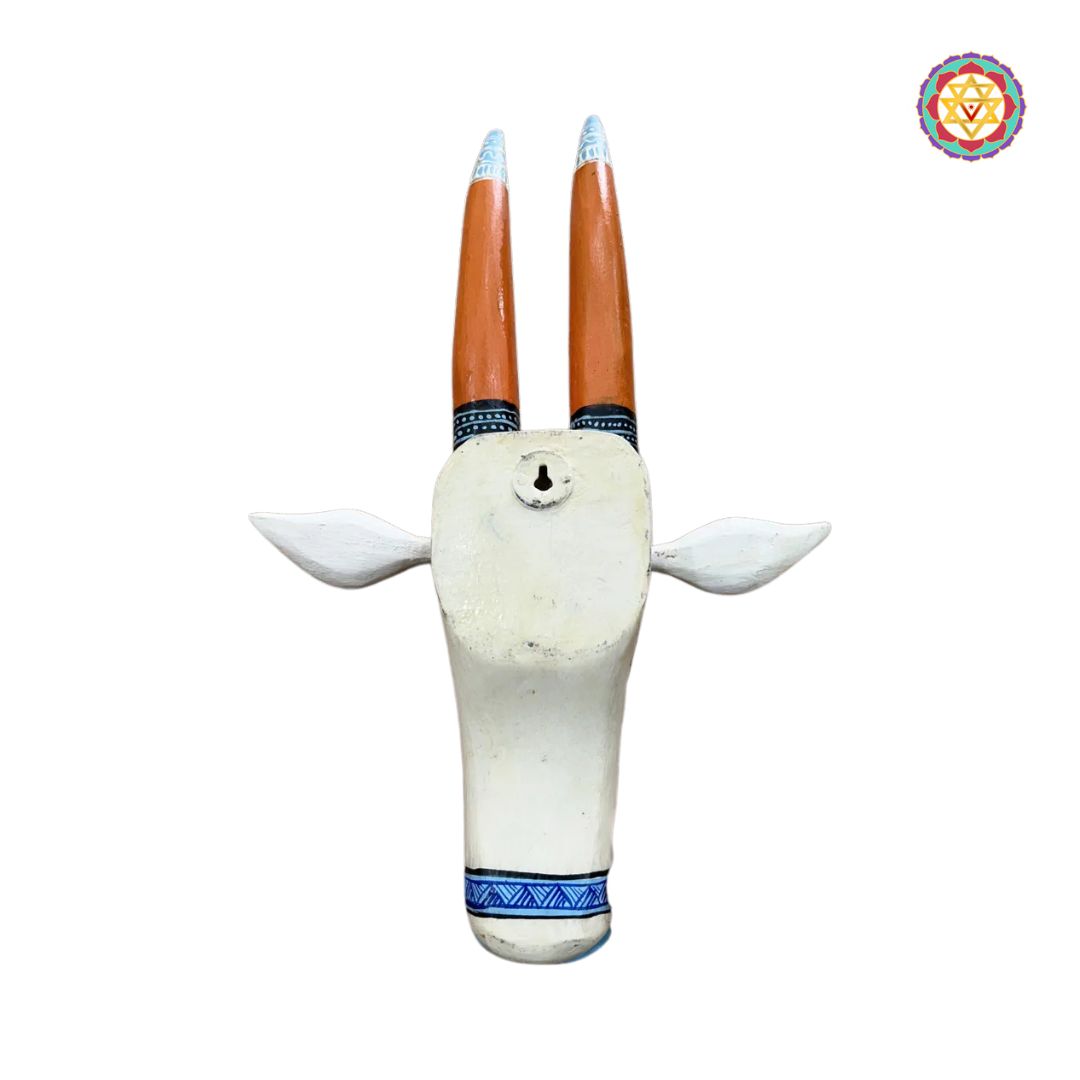 detailed carving of orange and blue nandi cow head showing textured finish and handwork