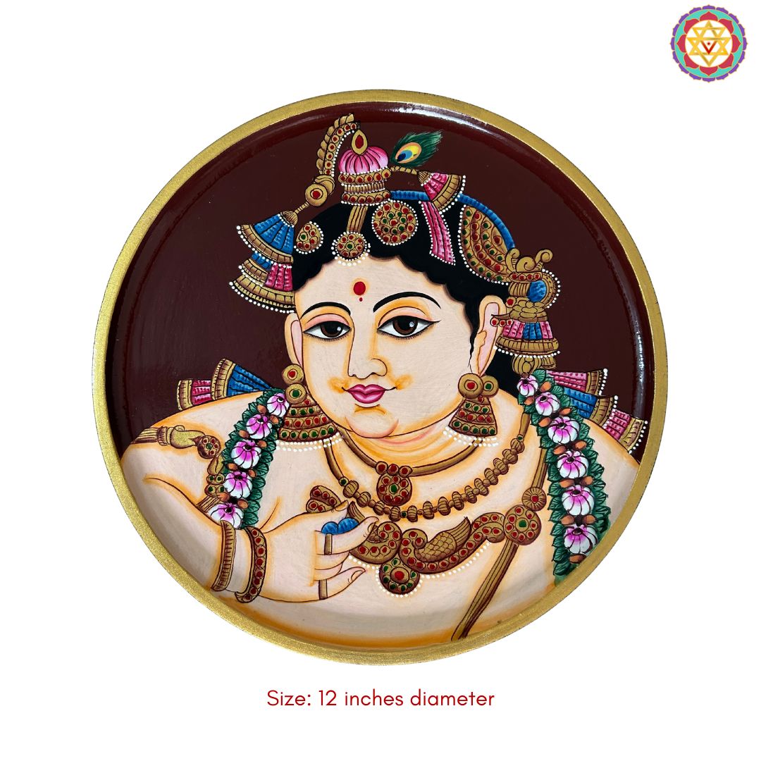 close up baby krishna tanjore plate with gold accent details