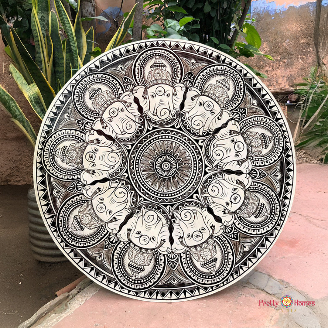 Monochrome pattachitra wall plate showing various forms of Ganesha