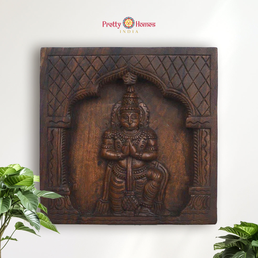 Handcarved wooden panel showing Lord Hanuman in kneeling pose