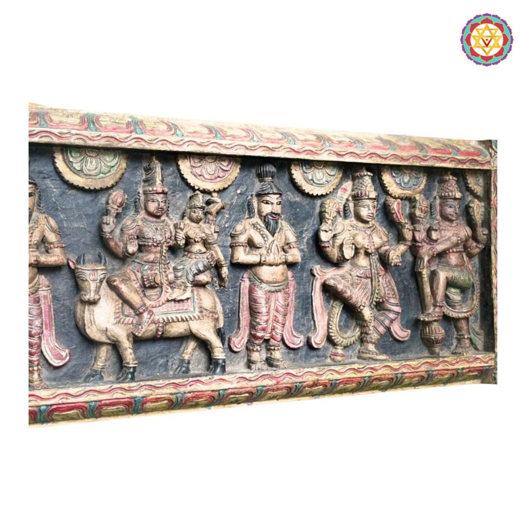 horizontal antique style carved panel shiva parvati on nandi with deities angled shot highlighting depth and wood carving texture