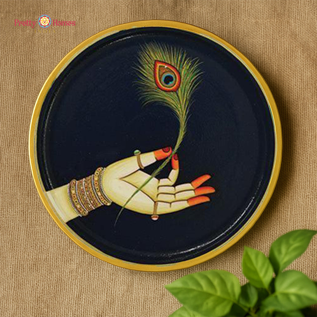 close-up of radha krishna hands artwork on handcrafted plates
