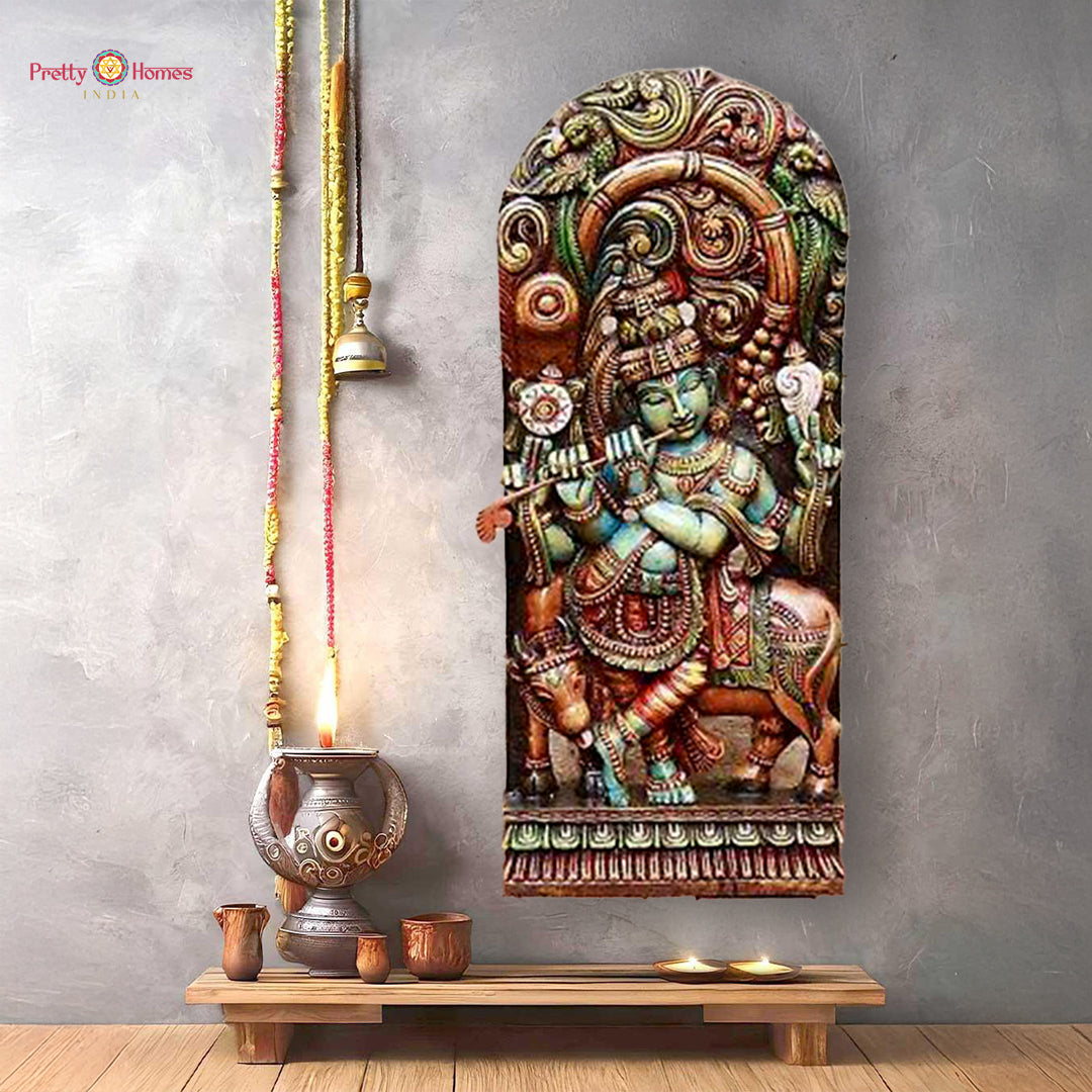 Wooden sculpture of Lord Krishna standing under canopy with sacred cow