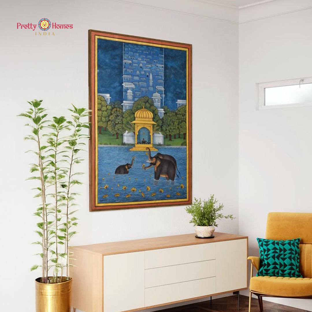 Large framed pichwai print showing elephants in water with temple and lotus accents for wall decor