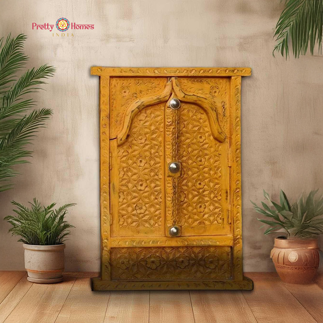 Close-up of carved wooden window wall hanging showing embossed brass work and vibrant color palette — artisan craftsmanship