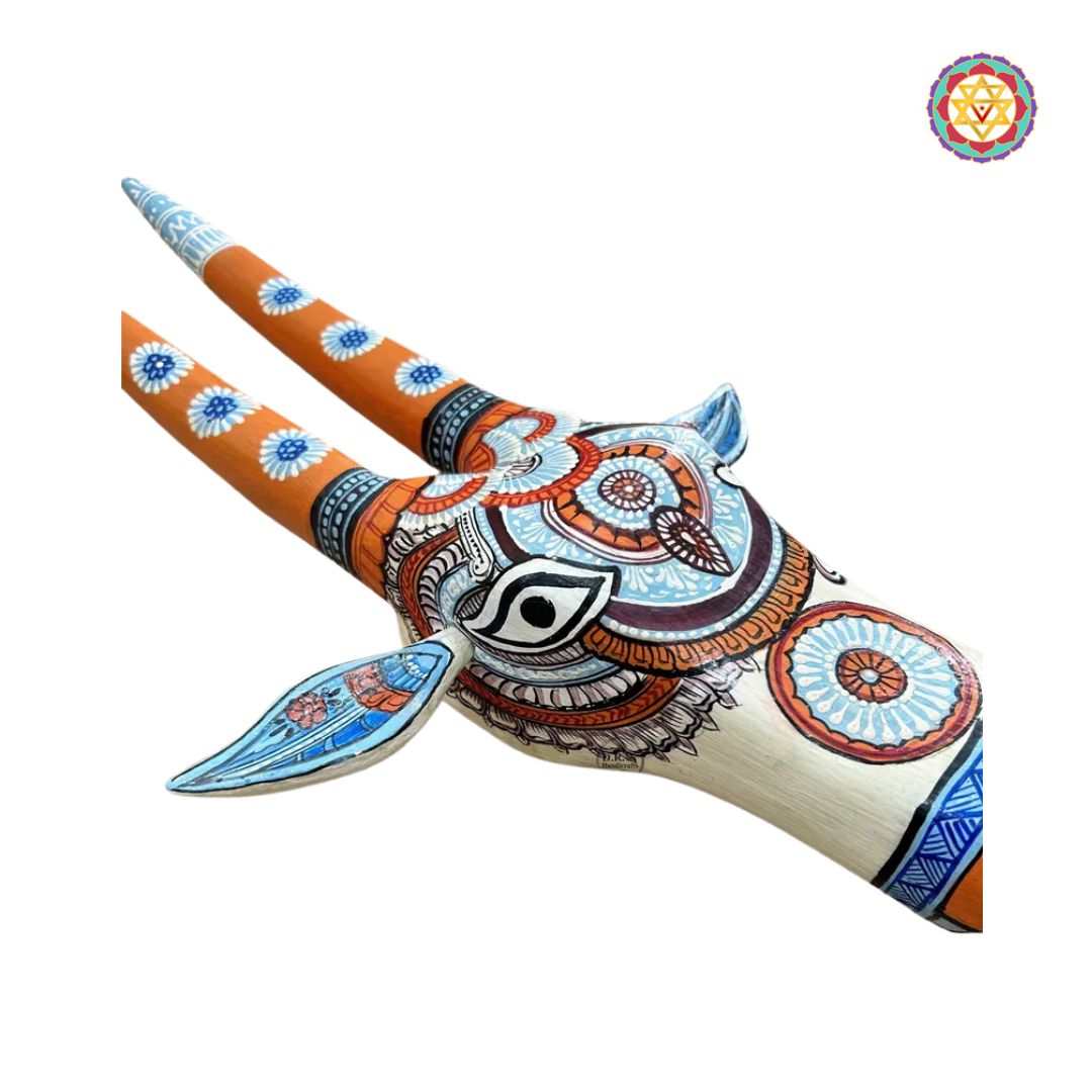 side view of orange and blue nandi head wall decor with fine painted detailing
