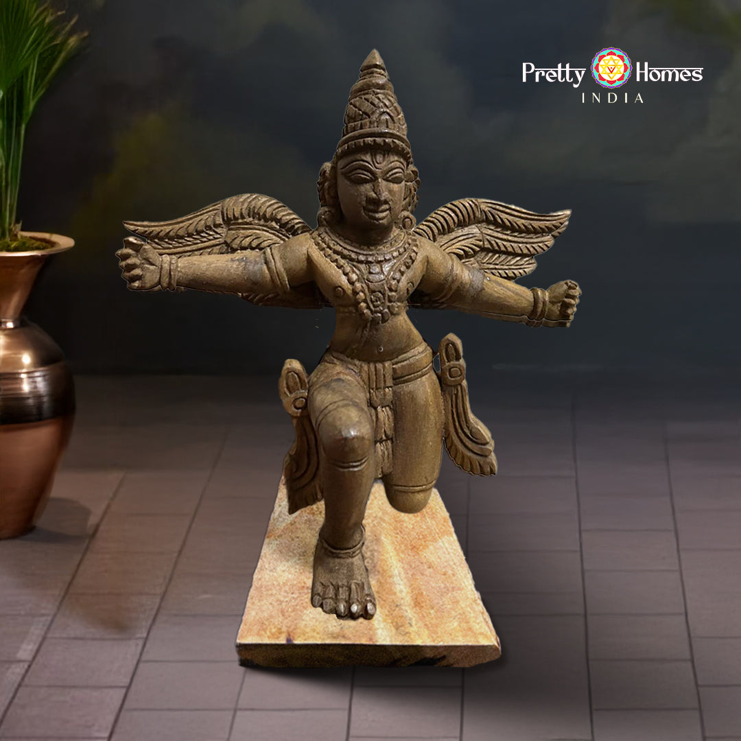 hand-carved garuda wooden sculpture on pedestal base