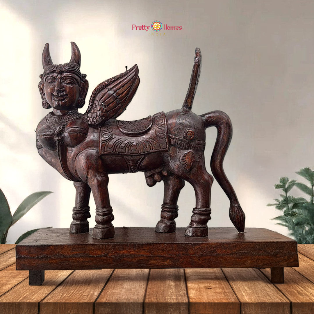 Handcarved wooden Kamdhenu statue with calf and ornate detailing