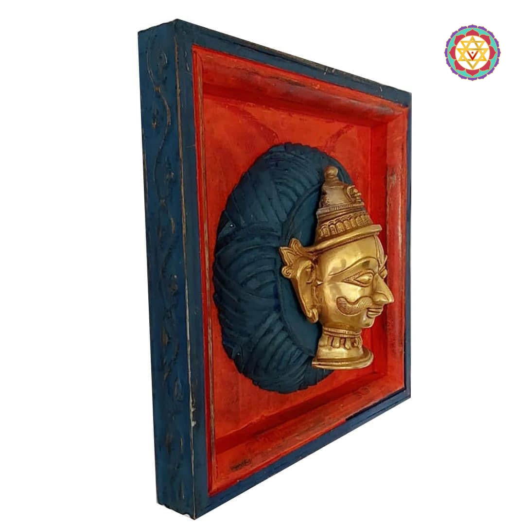 Brass Parvati / Shiva mukhalingam on wood carved frames.