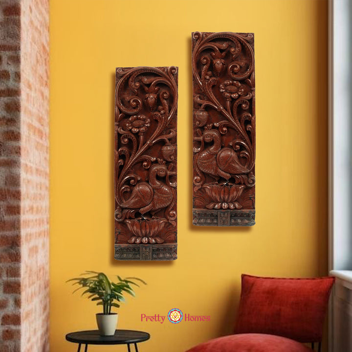 "Handcarved wooden Annam and lotus wall panels set against a yellow wall"