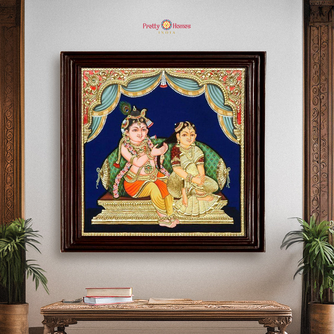Framed Radha Krishna Tanjore painting in 22-carat gold foil displayed on a wall