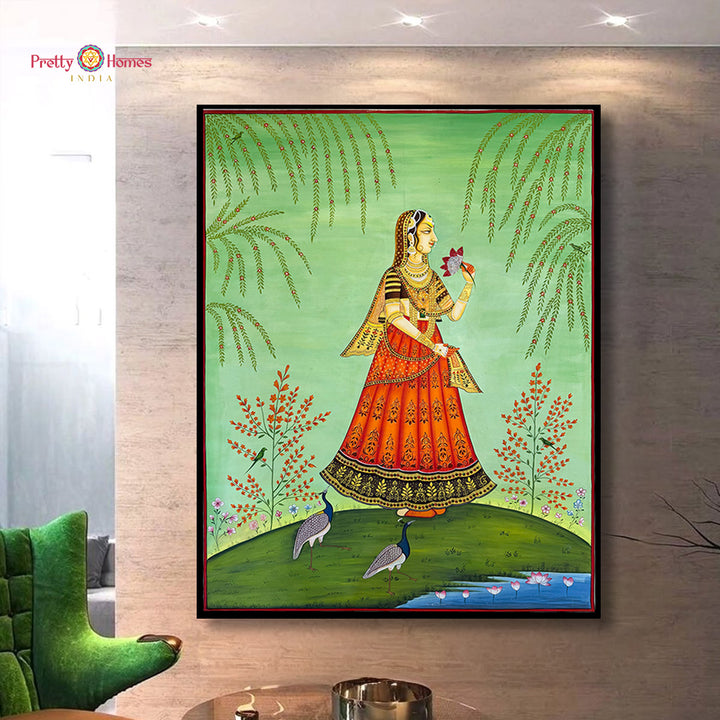 Framed artwork of a traditional Indian woman in an orange dress on a wall in a living room.
