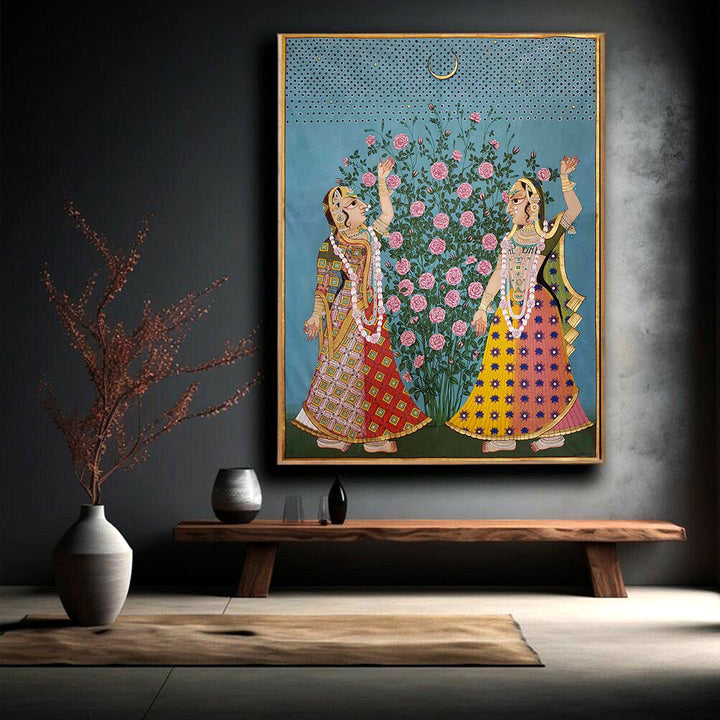 Hand-painted pichwai artwork of Gopikas under the moon and flowers, displayed in a modern room.