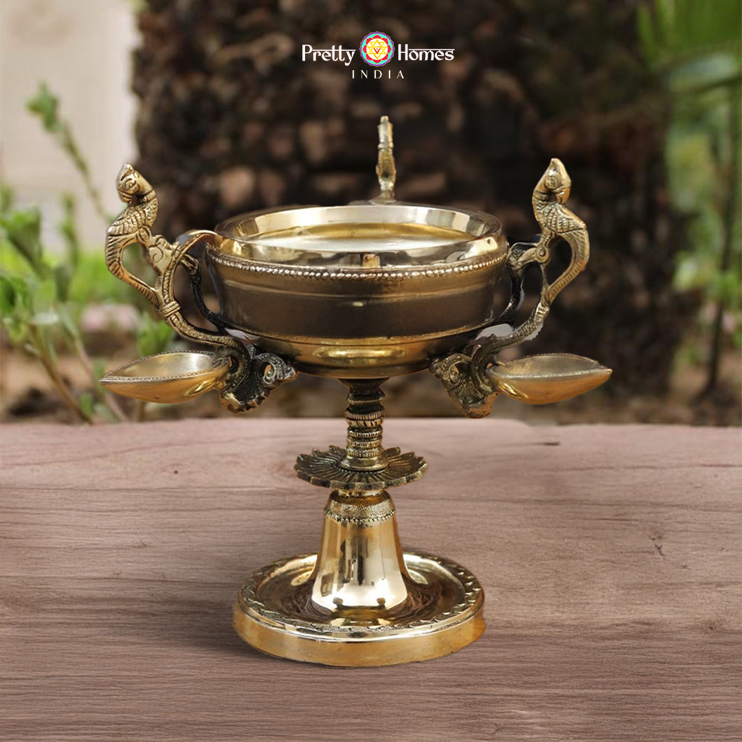 brass diya with peacock handles in traditional golden finish