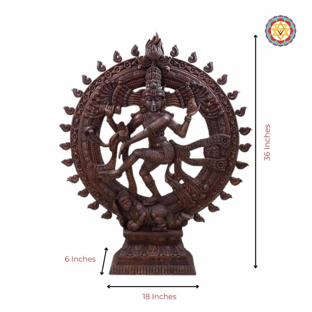 wood-carved nataraja statue depicting lord shiva in cosmic dance pose with detailed circular halo and intricate base carvings