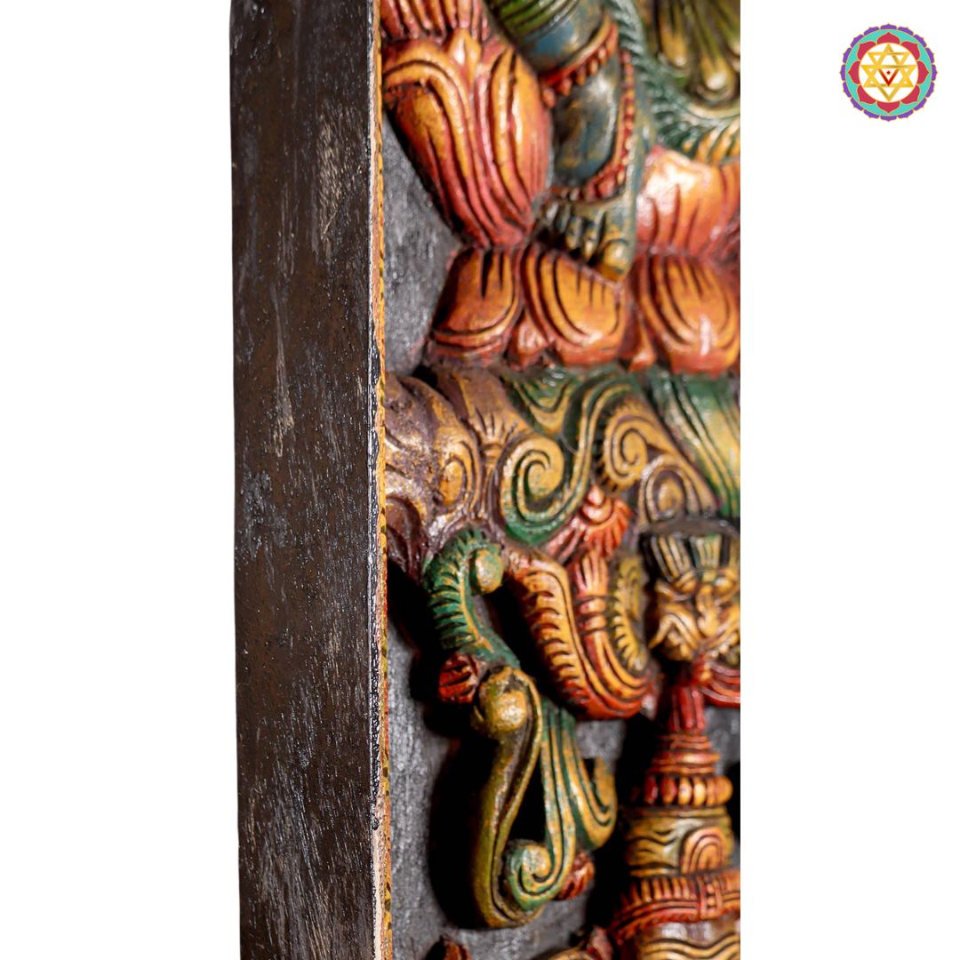 Detailed wooden carving of Ganesha panel with traditional motifs