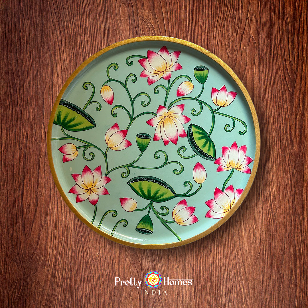 Hand painted pichwai design wall plate with lotus clusters and green leaves