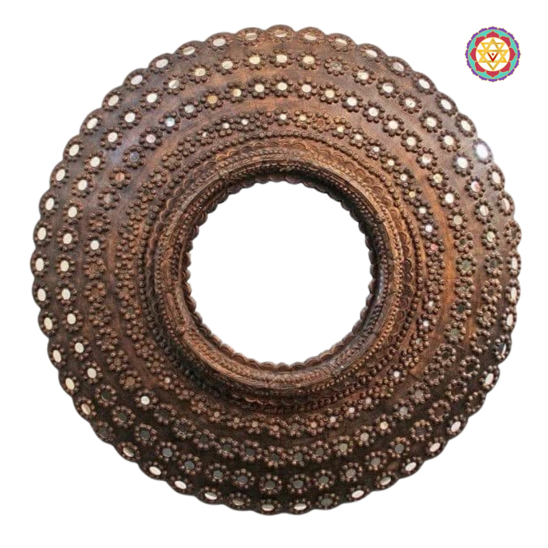 Top view of peacock style carved wooden round frame