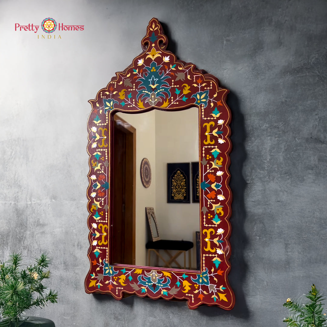 Multicolour handpainted mirror frame mounted on a grey wall