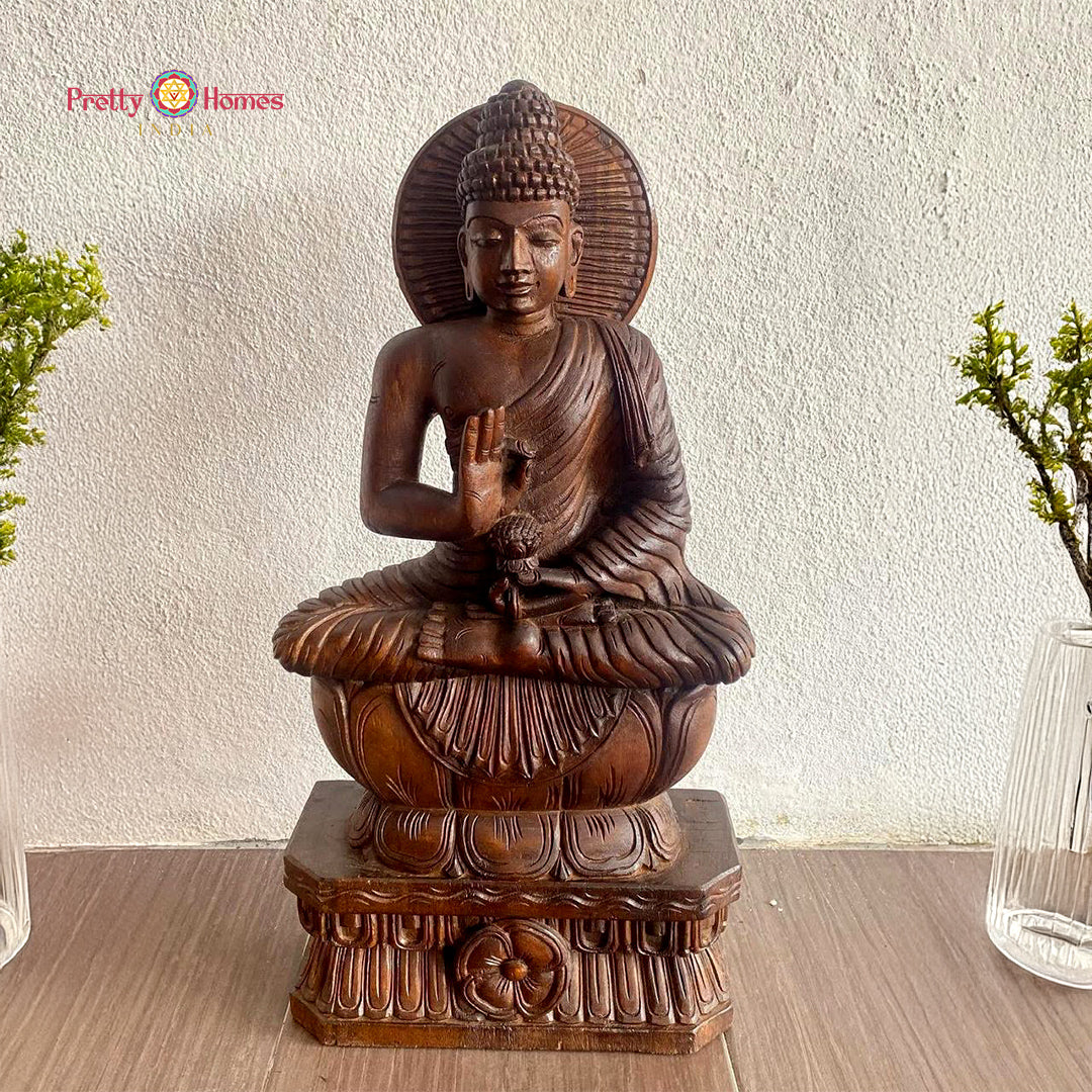 wood carved serene buddha statue in blessing pose