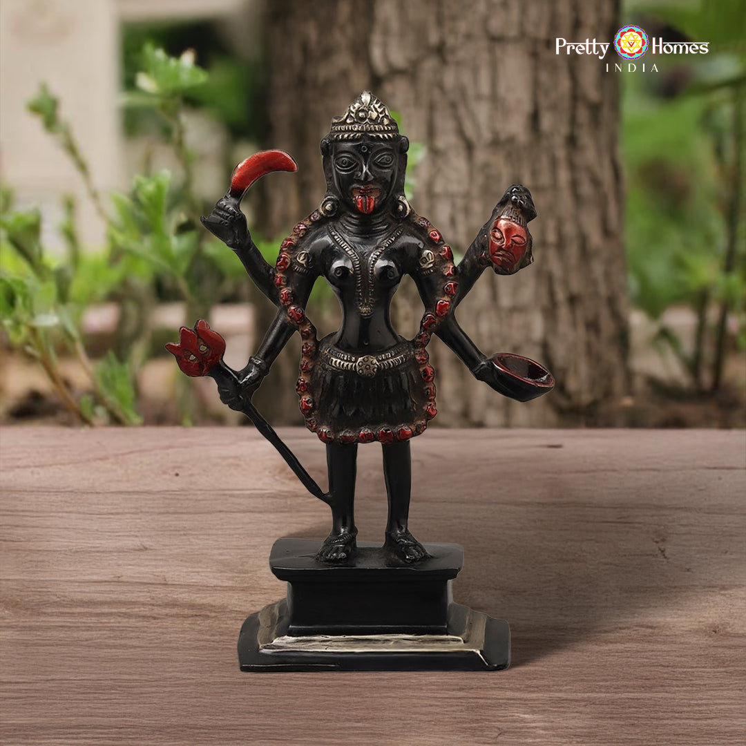 multicolored brass Kali statue with expressive posture and painted details