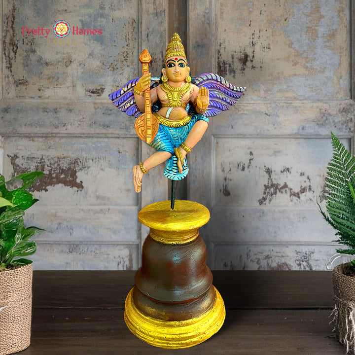 Beautifully handcarved Gandharva (Indian Angel) playing the Veena, crafted on a sturdy wooden stand.