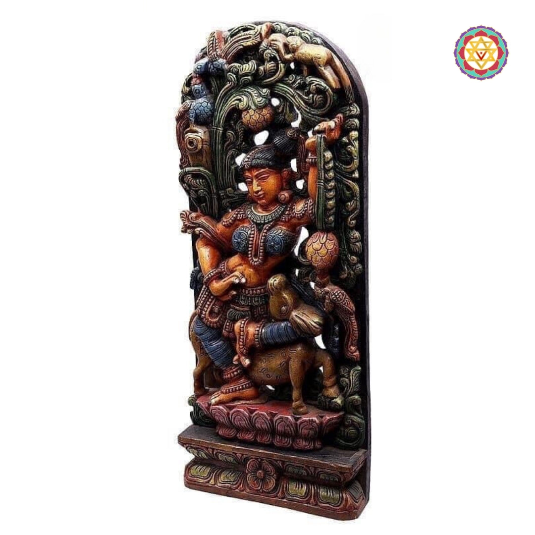 Side profile of wooden Apsara sculpture showing elegant posture and handcarved detailing