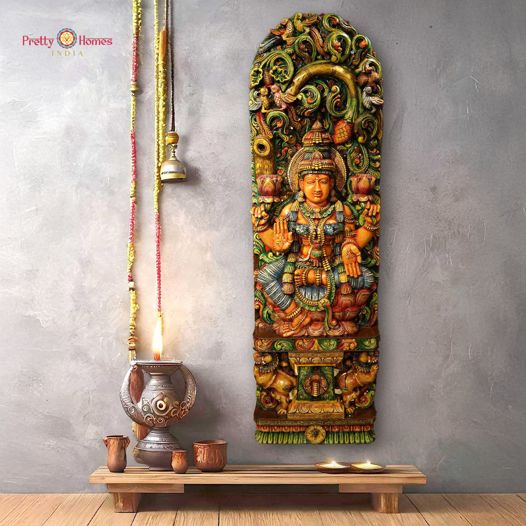 Handcarved wooden Goddess Lakshmi sculpture under ornate canopy design