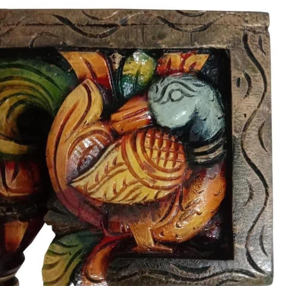 Detailed view of bodhil bracket showing swan carving with elegant scroll patterns and floral relief