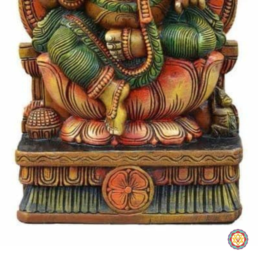 Close-up of wooden Ganesha sculpture showing intricate handwork and antique gold polish finish