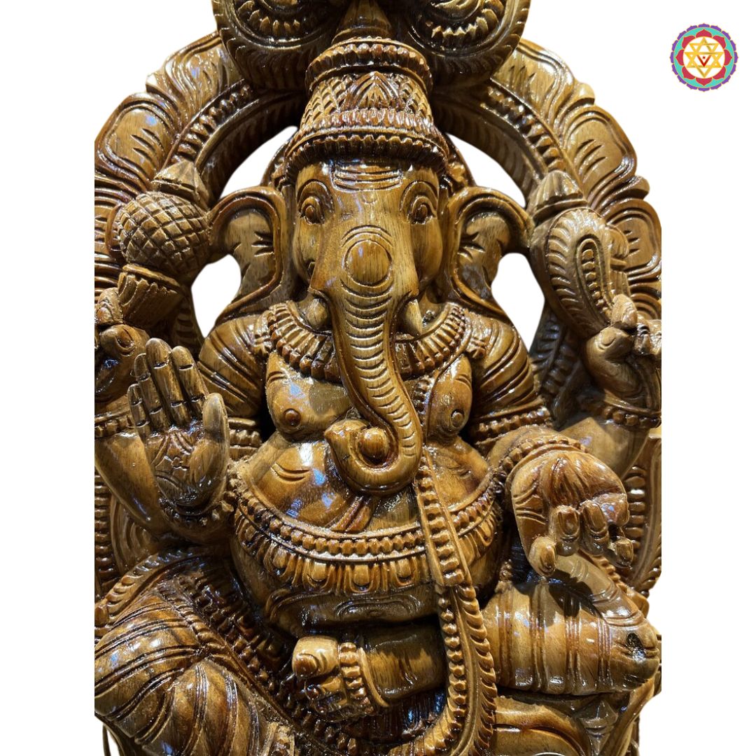 Front view of wooden Ganesha handcarved statue — detailed ornaments, crown, and posture, antique finish devotional idol