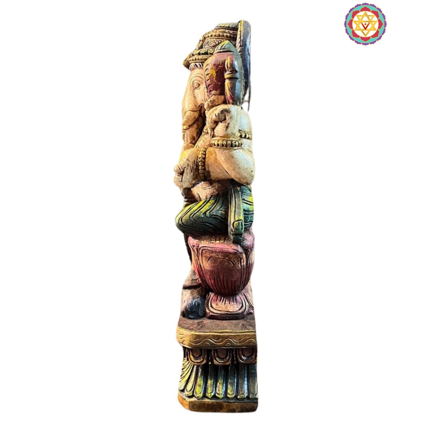 Side view of Ganesha wooden statue — intricate robe carving and polished surface, sacred Hindu deity art