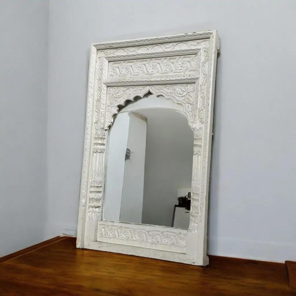 Installed jharokha-style mirror — traditional handcrafted wooden art.